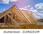 Timber frame house of gables roof on stick built home under construction new build roof with wooden beam framework
