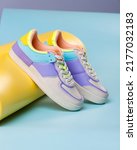 Small photo of Close up of trendy colored sneakers for teenage girls on colorful yellow-blue background. White sneakers with laces with variety of colored inserts. Sports shoes concept. Close-up.