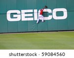 Small photo of WASHINGTON - AUGUST 14: Roger Bernadina of the Washington Nationals attempts a catch at the wall in the Nationals' home game against the Arizona Diamondbacks on August 14, 2010 in Washington.