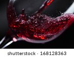  Red wine in wineglass on  black background
