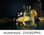 Small photo of Cocktail gin tonic with ice, lemon, and rosemary. Refreshing drink with natural ice in a frozen glass.