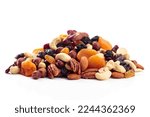 Mix of nuts and dried fruits isolated on a white background. Presented apricots, raisins, walnuts, hazelnuts, cashews, pecans, and almonds.