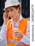 Small photo of Female site supervisor suffering from unilateral temporal headache