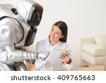 Nice girl using tablet with robot