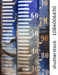 Small photo of Vintage Amsterdam Ordnance Datum benchmark signs for measuring the water level in Dutch rivers and lakes