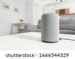 Smart speaker device in living room. Intelligent assistant in smart home system.