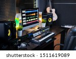 Small photo of Electrical equipment for music recording and computer monitor with sound mixing tracks on workplace of deejay or modern musician in studio