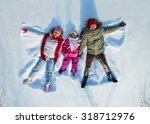 Happy family of three having fun in snowdrift
