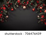 Christmas decoration with fir branches and red berries on a dark background