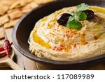 A Bowl Of Creamy Hummus With...