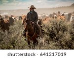 Cowboy Leading Horse Herd...