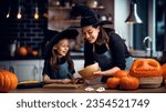 Small photo of Mother and her daughter having fun at home. Happy Family preparing for Halloween. Mum and child cooking festive fare in the kitchen.