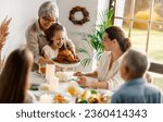Small photo of Thanksgiving Day, Autumn feast. Happy family sitting at the table and celebrating holiday. Grandparents, mother and children. Traditional dinner.