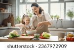 Small photo of Healthy food at home. Happy family in the kitchen. Mother and child daughter are preparing proper meal.