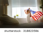 Child Holds A Flag Of America