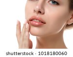 Close up view of young beautiful caucasian woman face isolated over white background. Lips contouring, SPA therapy, skincare, cosmetology and plastic surgery concept