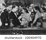 Couple having drink at crowded bar
