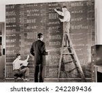 General Motors managers at a large control board, which resembles a spreadsheet, keep check on flow of materials needed for the wartime production. 1941.