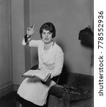 Small photo of Aimee Semple McPherson, in a preaching pose, Feb. 14, 1927. She had recently emerged from a prosecutorial investigation of her alleged 1926 kidnap and disappearance