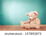 Teddy Bear toy alone on wood in front mint green background