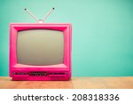 Retro old pink television front mint green background