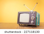 Retro old portable television from 80s front gradient yellow background