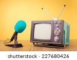Retro old portable TV and microphone front gradient yellow background
