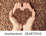Coffee Beans In The Hands Of...