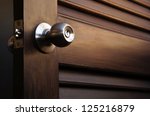 wooden door with grill, stainless door knob or handle on wooden door in beautiful lighting