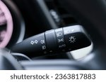 Small photo of turn signal switch, headlight fog lamp dimmer control switch, multifunction switch in modern car, shallow depth of field