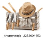 Small photo of Gardening tools set, wooden crate with aluminum garden kit tools, Trowel with wooden handle, straw hat and protective gloves, isolated on white background. Concept of work or sale garden products