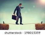 Small photo of businessman in a predicament balancing on a tightrope