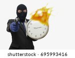 Small photo of Businessman robbery time While the watch fire burn. Time management concept provides value.