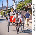 Small photo of KYOTO, JAPAN-OCT 24,2014: Jinrikisha driven by an unidentified driver carrying two tourists in Kyoto on Oct 24, 2014, ,Japan.The word jinrikisha is of Japanese origin and means human-powered vehicle.