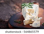 Blue cheese on the old wooden background.