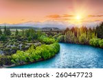 Beautiful sunset over the bend of the river Clutha with Southern Alps peaks on the horizon, New Zealand