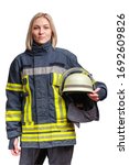 Small photo of young caucasian woman firefighter in fireproof uniform stands and looks at the camera with helmet in her hands. Isolated on white
