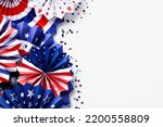 USA paper fans and confetti on white desk table, top view. Happy Labor Day, Independence Day, Presidents Day banner mockup
