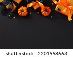 Halloween background with gift boxes, pumpkins, spiders, bats on black. Happy Halloween holiday sale, discount, promotion banner template.