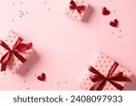 Valentine's Day flat lay composition with gift boxes and hearts on pastel pink background. Flat lay, top view, copy space.