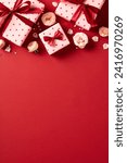 Small photo of Valentine's Day vertical background, poster design. Flat lay Valentines gift boxes decorated ribbon bows, roses buds on red background.