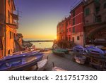 Riomaggiore village street, boats and sea in at sunset, Cinque Terre National Park, Liguria region, Italy, Europe.