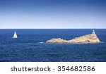 Elba island, Portoferraio Scoglietto little rock, boat and lighthouse. Tuscany, Italy.