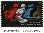 Small photo of UNITED STATES OF AMERICA - CIRCA 2018: forever post stamp printed in US (USA) shows firefighter with axe, EMS worker with emergency bag, police officer with flashlight; honoring first responders; Scot