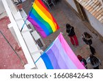 Small photo of The LGBT community flags on homes in the old city in a sign of friendly neighborliness and hospitality for all types of gender people. Somewhere on the streets of the old city in Spain, Europe.
