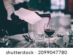 Waiter Pouring Red Wine Into A...