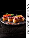 Small photo of Canape with brioche, Raw beef meat tartar, salmon red caviar.