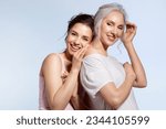 Small photo of Loving millennial daughter and adorable senior mother Hugging in good mood studio portrait. Parent and adult child enjoying sweet tender moment, family pastime together. Overjoyed beautiful people