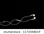 white earphone for listening music on black background