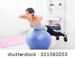Fitness young woman doing abdominal crunches on fit ball